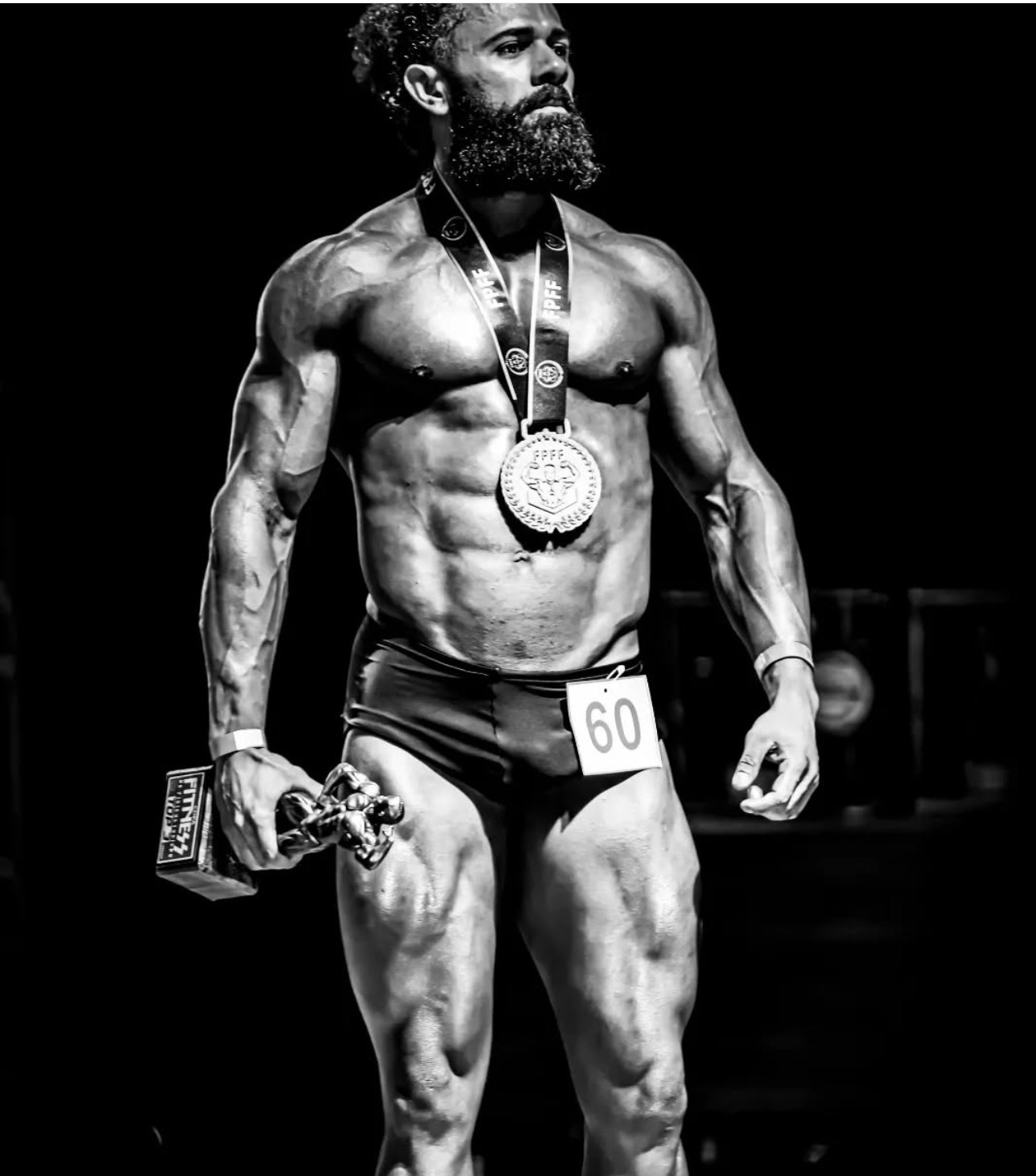 Joab Pereira on stage as a bodybuilding competition winner